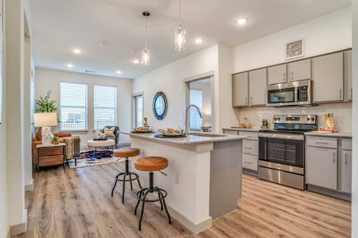 A modern kitchen with a bar stool and a countertop.