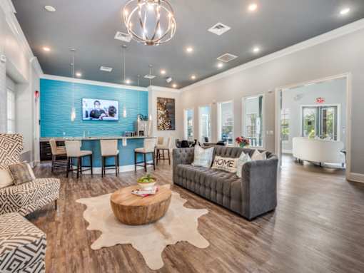 A living room with a blue accent wall and a television.