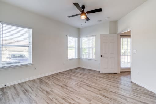 an empty room with colorful lights on the ceiling and a wooden floor