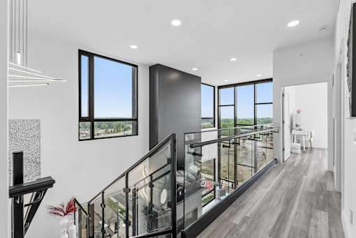 A modern interior with a staircase leading to the upper floor.