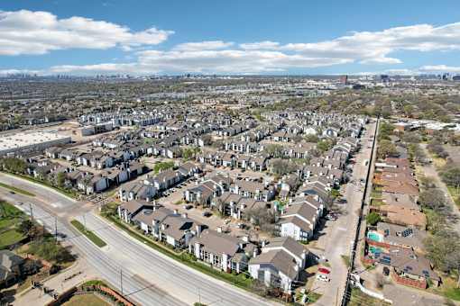 A suburban neighborhood with houses and a road.