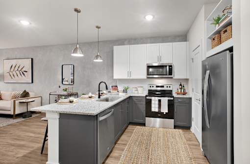 A modern kitchen with a large island and stainless steel appliances.