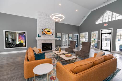 a living room with couches and chairs and a fireplace