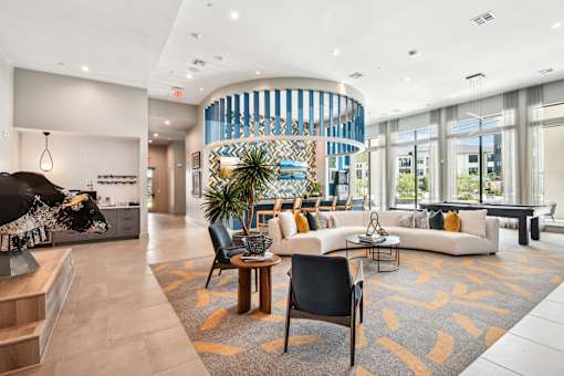 A modern living room with a curved wall and a large window.