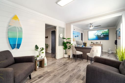 a living room with a couch and a desk and a surfboard