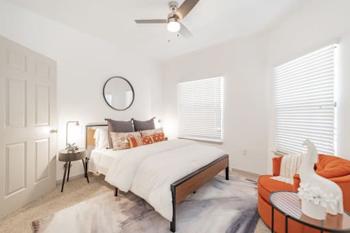 a bedroom with a large bed and a ceiling fan