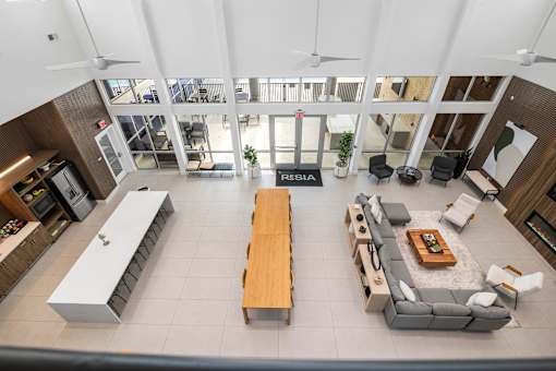A modern living room with a long wooden table and a sofa.