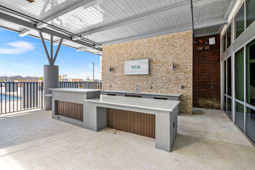 A reception area with a sign that says "PRISIA" on a brick wall.