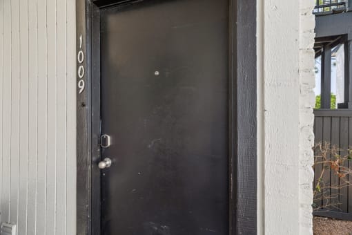 the front door of a house with a black door