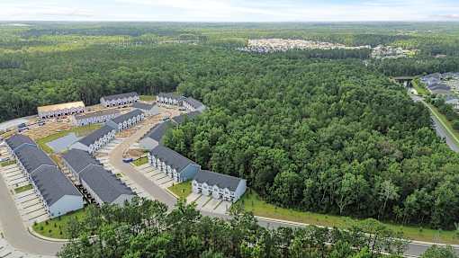 A bird's eye view of a resort surrounded by trees.