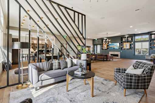 A living room with a grey sofa, a black and white checkered armchair, and a wooden coffee table.