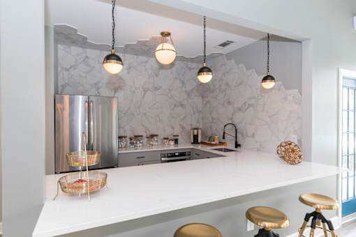 a kitchen with a long counter top and a refrigerator
