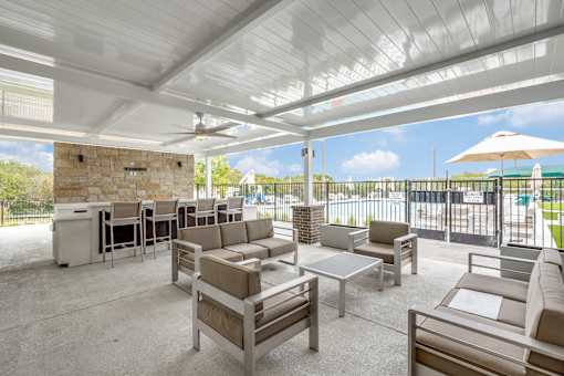 A patio with a white ceiling and furniture.