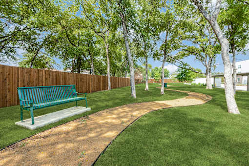 A park with a bench and a path.