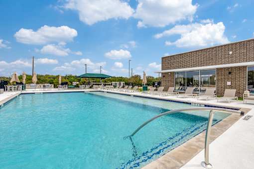 A large swimming pool with a metal ladder in the middle.