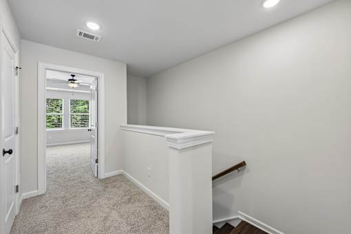 A room with white walls and a carpeted floor.