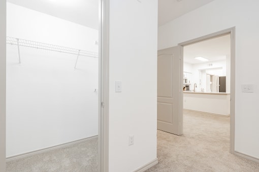 a large white room with white walls and a mirror