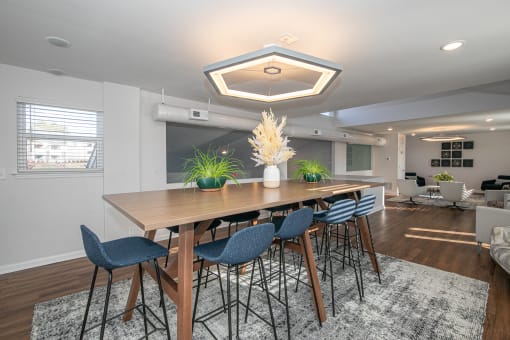a dining room with a wooden table and blue chairs