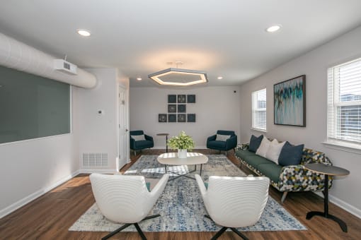 a living room with a couch and chairs and a table