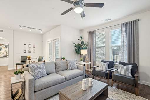 A living room with a grey couch and a wooden coffee table.