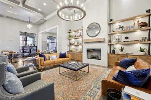 A living room with a fireplace and a large mirror on the wall.