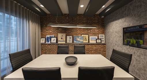 A conference room with a long table and chairs.