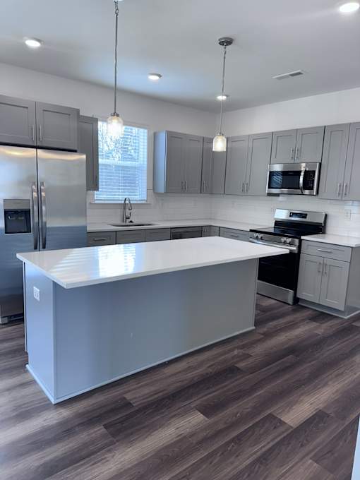 A modern kitchen with a large island in the center.