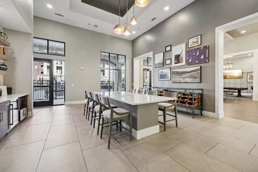 A kitchen with a bar area and a dining table.