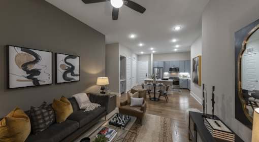 A modern living room with a grey couch and a rug.