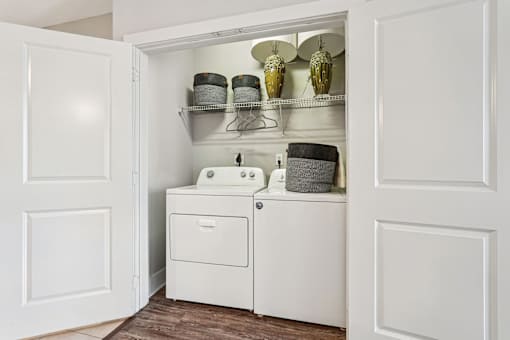 A white bathroom cabinet with a sink and a cabinet door open.