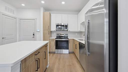 A modern kitchen with a refrigerator on the right.