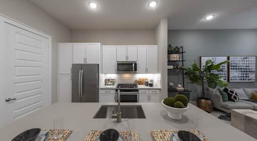 A modern kitchen with a dining table set for four.