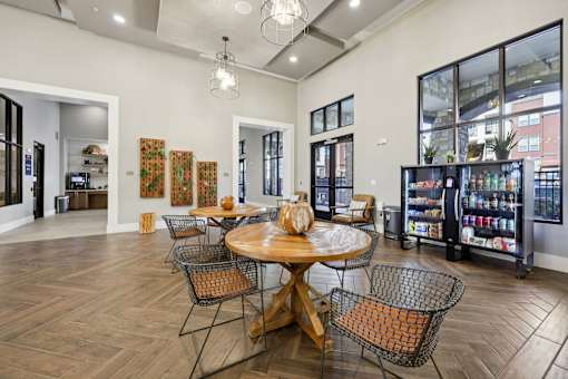 A dining room with a wooden table surrounded by chairs.
