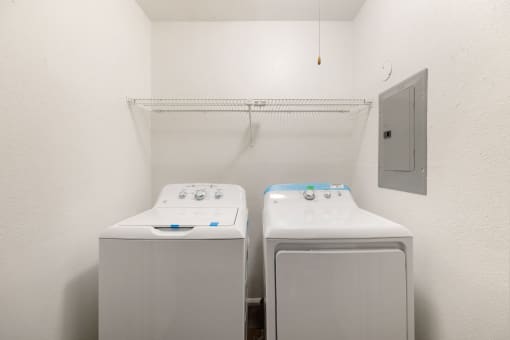 two washers and dryers in a laundry room with a door