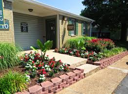 a house with a flower garden in front of it
