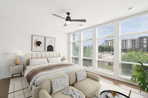 A bedroom with a large bed and a couch.