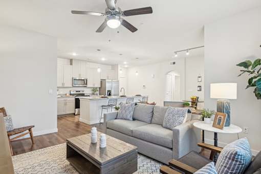 A living room with a grey couch and a wooden coffee table.