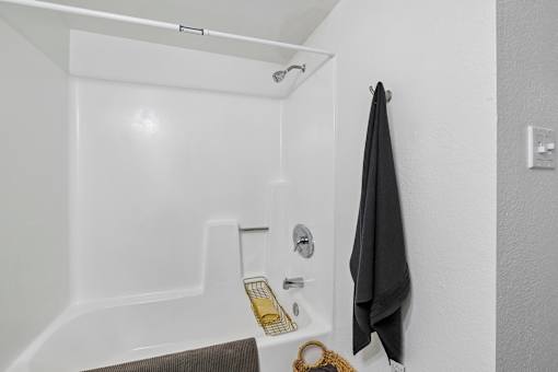 A bathroom with a black towel hanging on the wall.