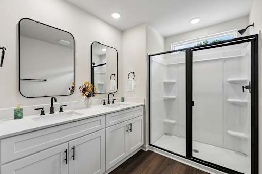 A bathroom with a white sink and a mirror above it.