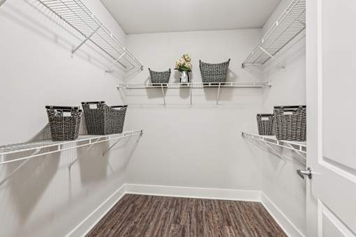 A white pantry with shelves and baskets.