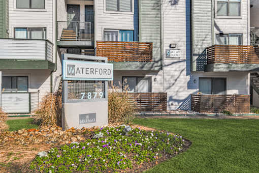 A sign in front of a building that says Waterford 7879.