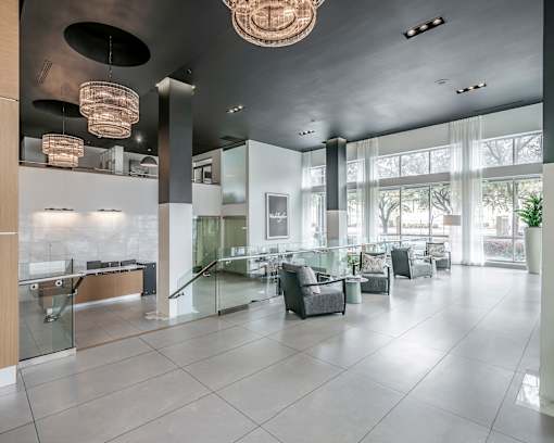 A spacious lobby with a reception desk and comfortable seating areas.