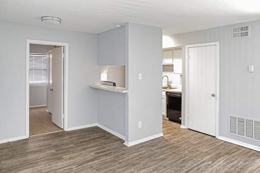 A kitchen area with a counter and cabinets.