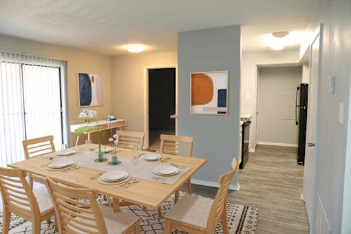 A dining room with a table set for two.