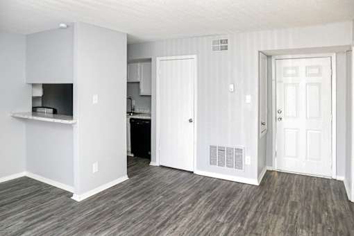 A kitchen area with a refrigerator, microwave, and oven.