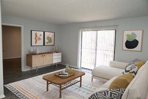 A living room with a white couch, a wooden coffee table, and a rug with a geometric pattern.