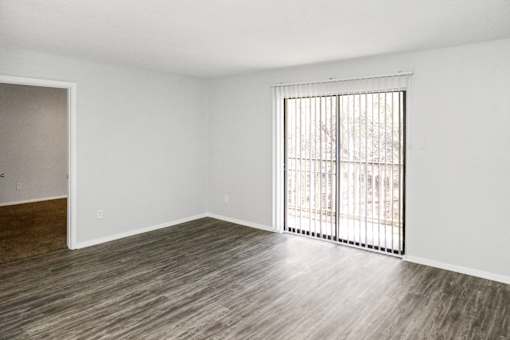 A room with a window and a sliding door.