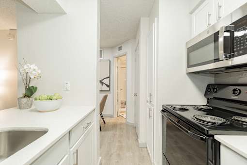A kitchen with a black stove top oven.