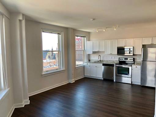 A kitchen with white cabinets and stainless steel appliances.