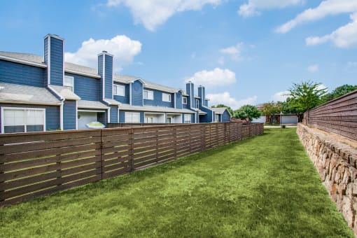 a long wooden fence in front of a row of houses